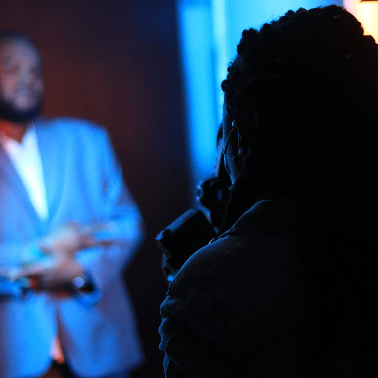 Behind the scenes of photographer taking photo of man in suit