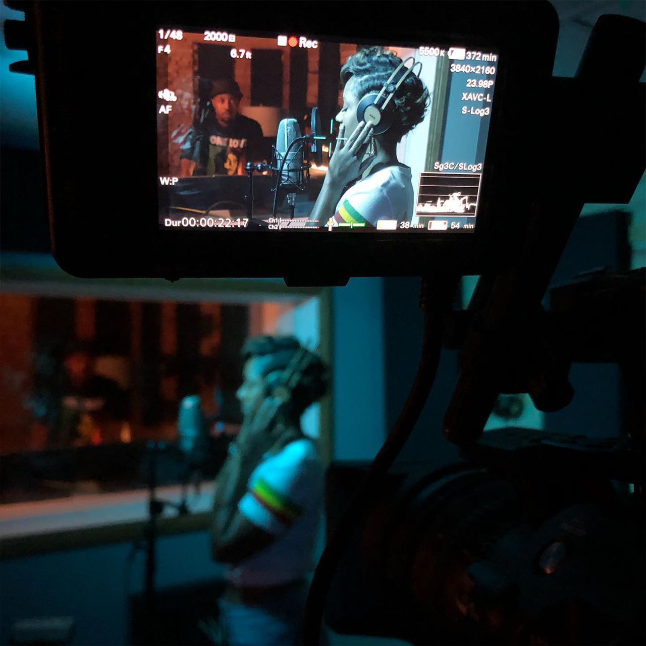 Woman in studio singing with headphones on