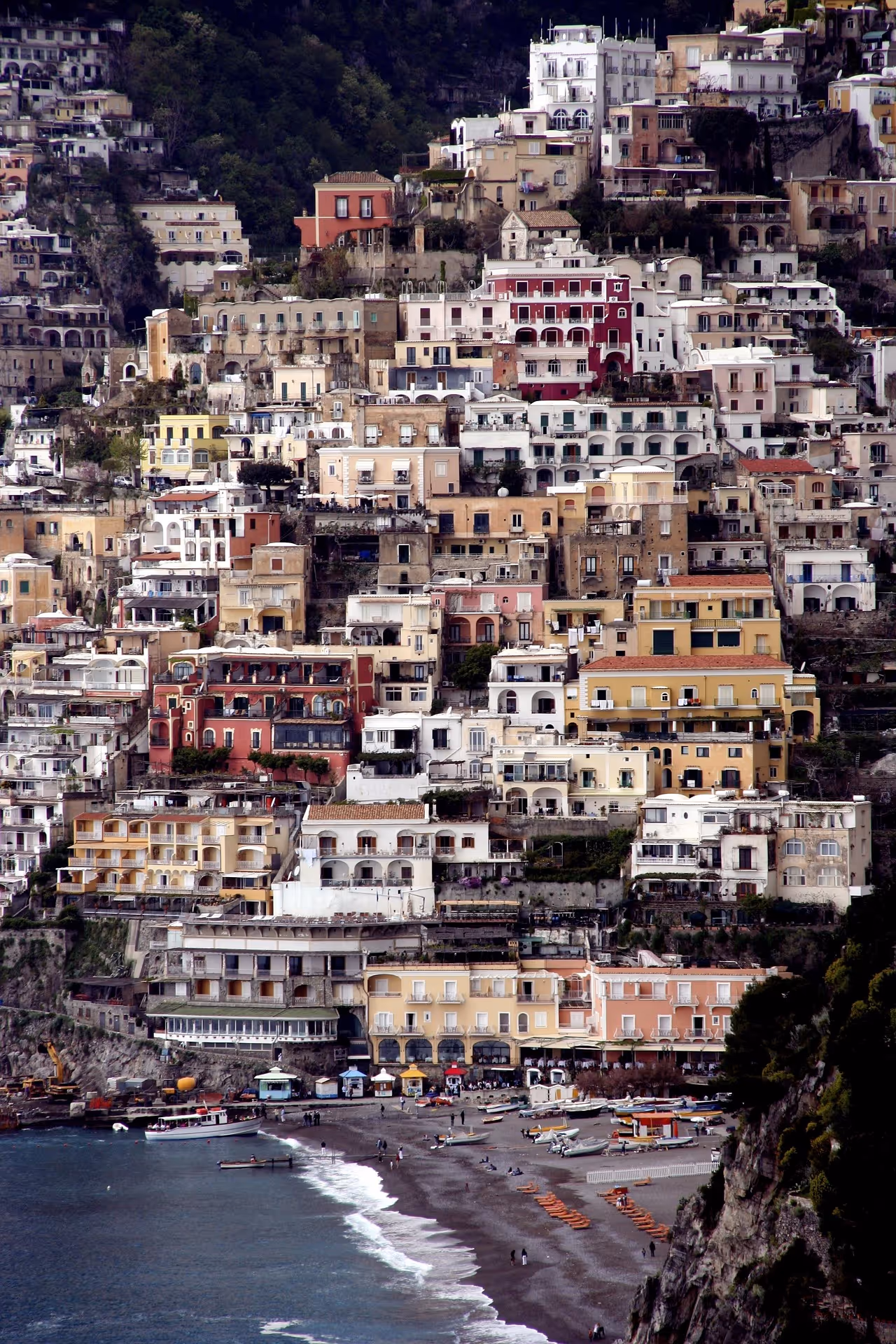 A city with many buildings and a mountain in the background.