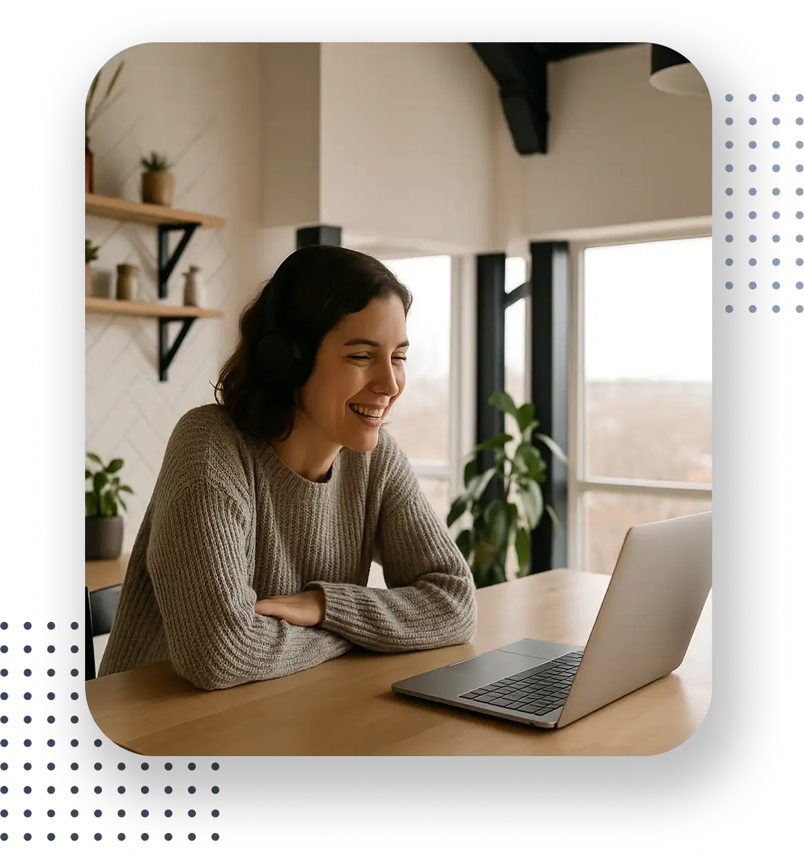 Woman smiling as she looks at her laptop computer