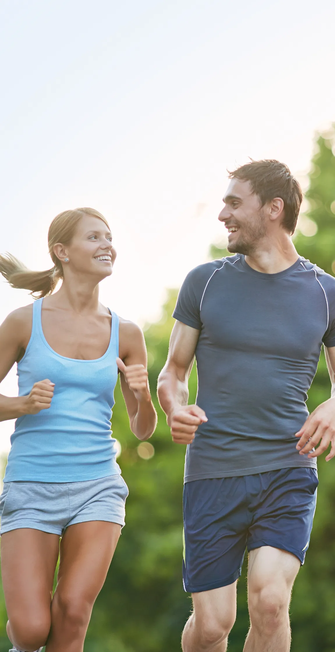Active couple jogging outdoors on a sunny day, representing the healthy lifestyle and recreational opportunities near Point Grey Mews on Vancouver’s West 4th Avenue.