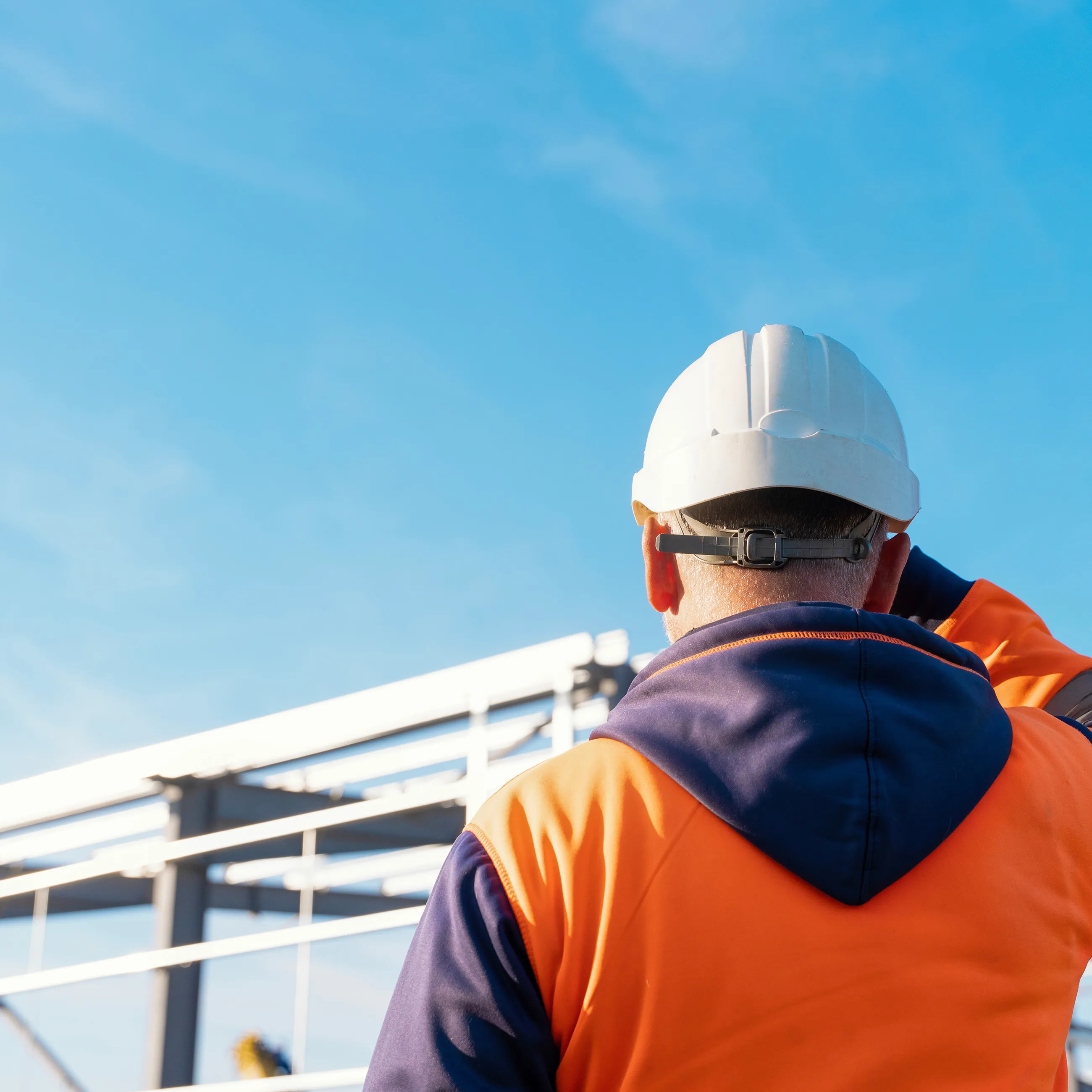 Builder watching construction process of new building