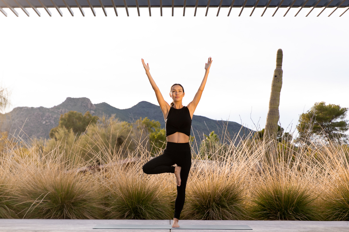 commercial photo of woman doing yoga in the desert