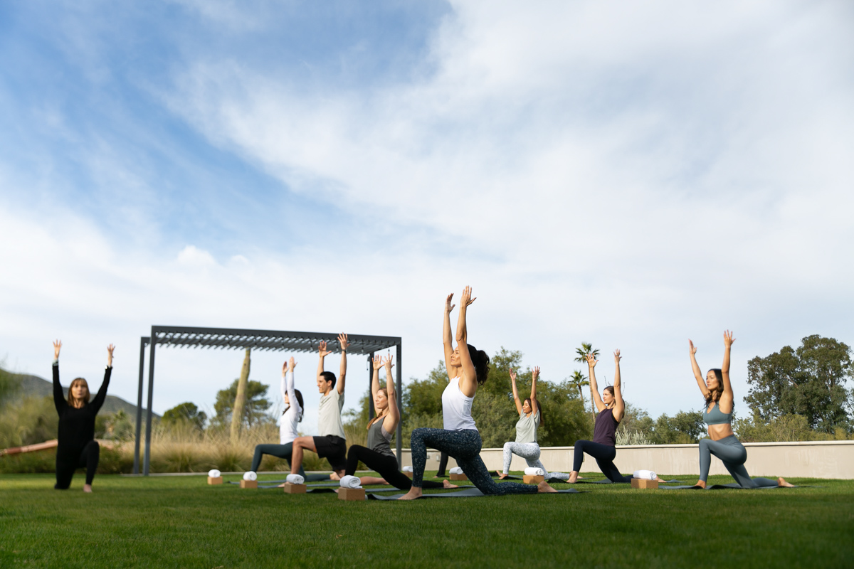 commercial photo of a group doing yoga outside