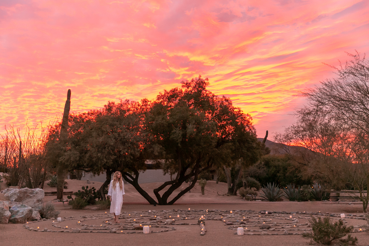 commercial photo of a woman walking through the labyrinth a luxury spa
