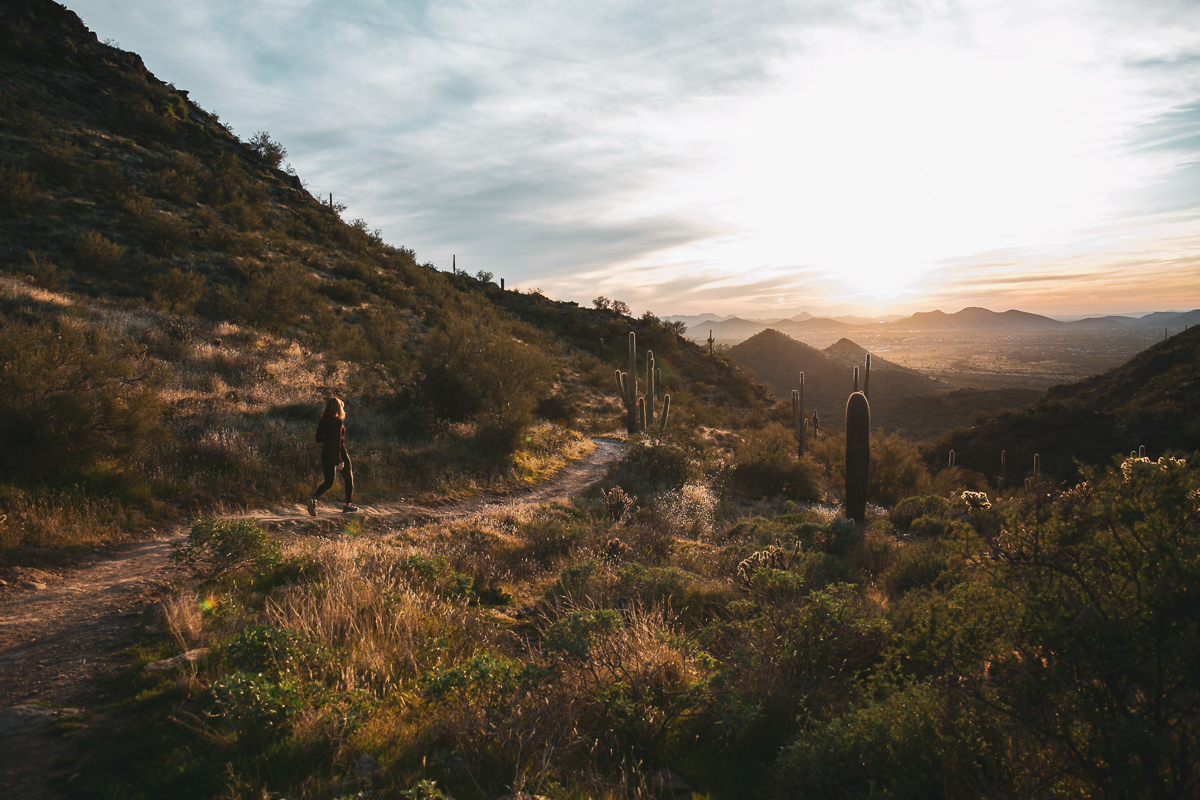 commercial photography of a woman running through the hills of the Arizona desert