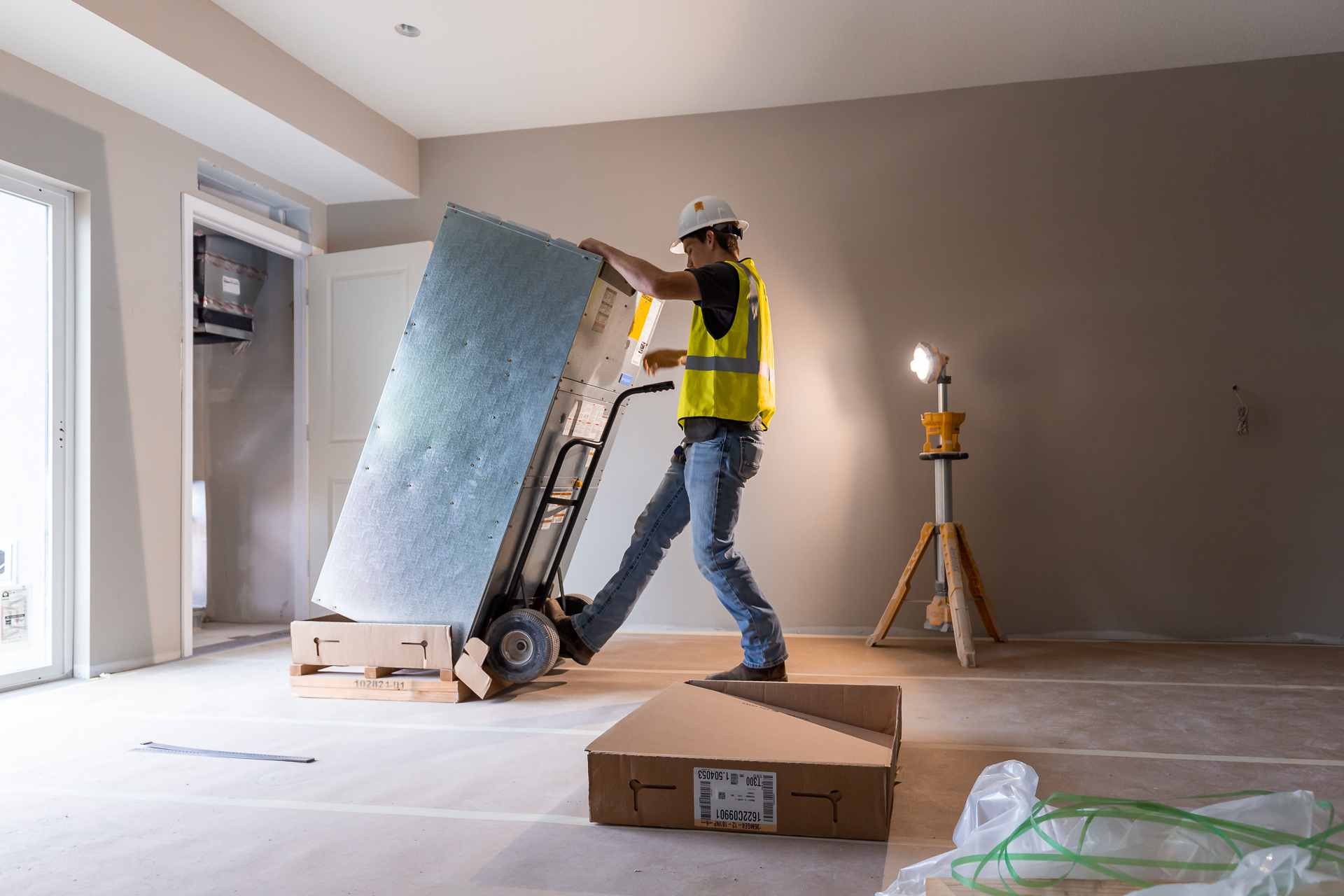 commercial photography of a man installing a HVAC unit