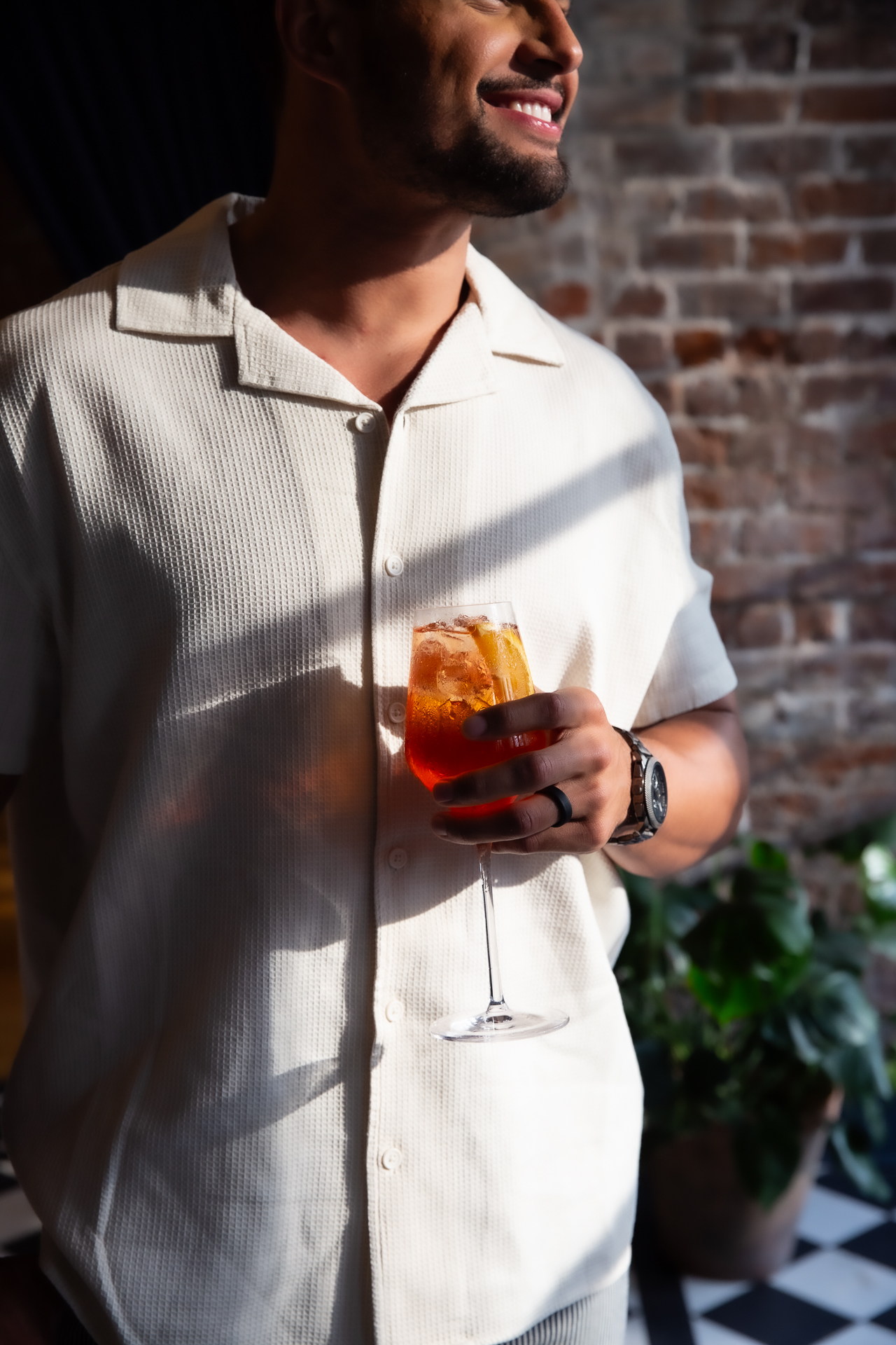 commercial photography of a man holding a cocktail at Eliza Jane hotel in New Orleans