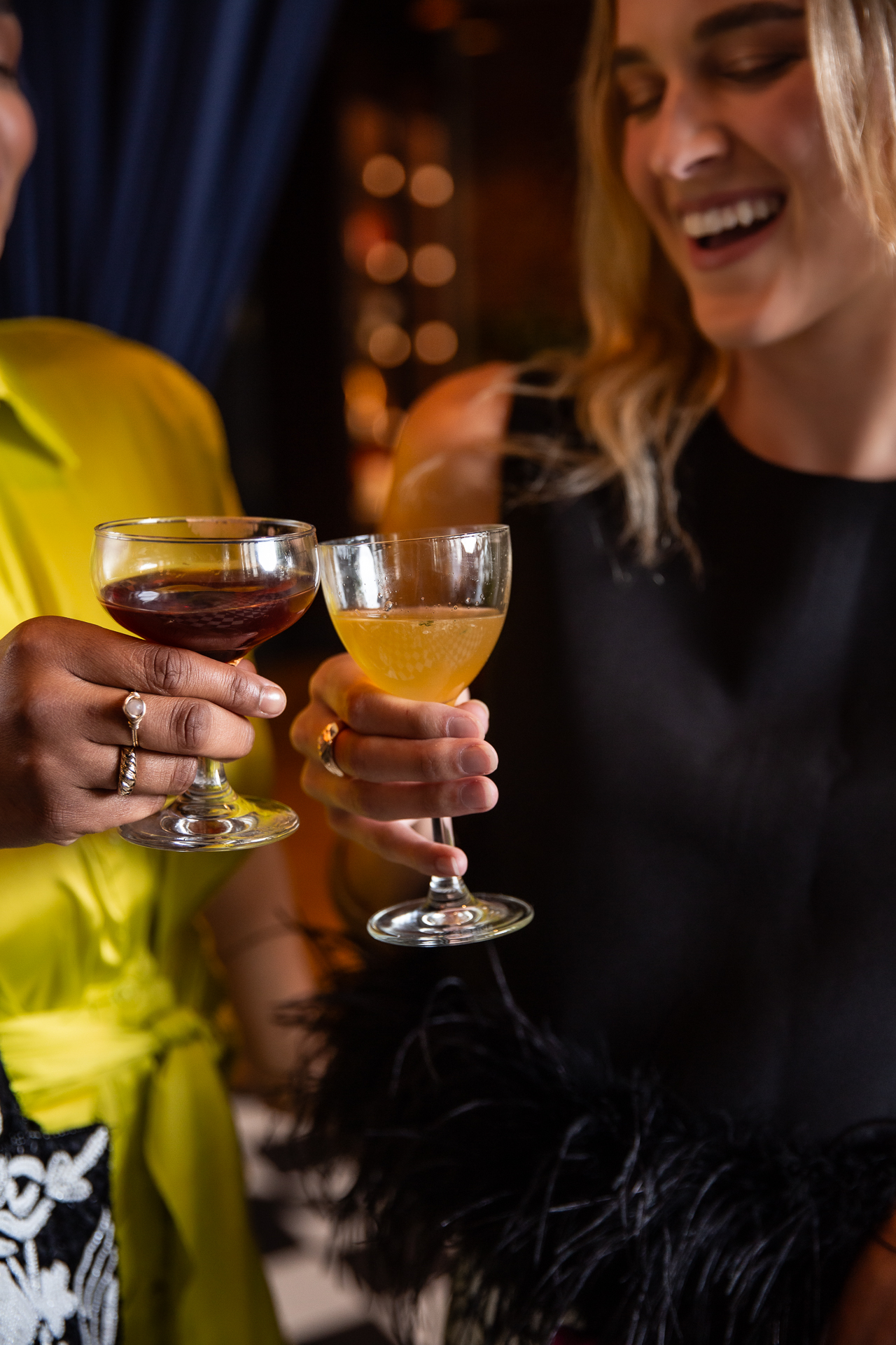 commercial photography of two women smiling with wine at Eliza Jane hotel in New Orleans