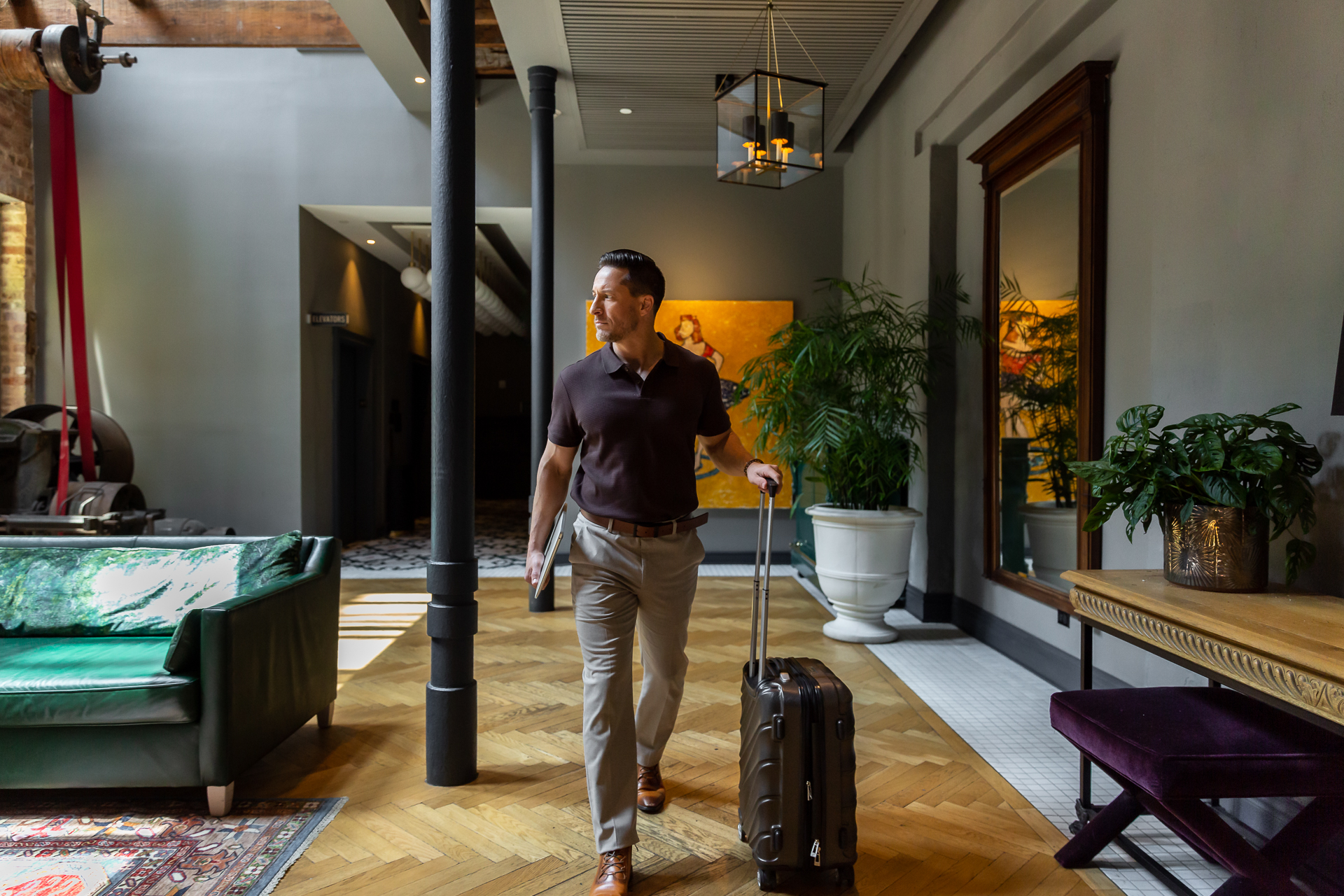 commercial photography of a man walking in the lobby at Eliza Jane hotel in New Orleans