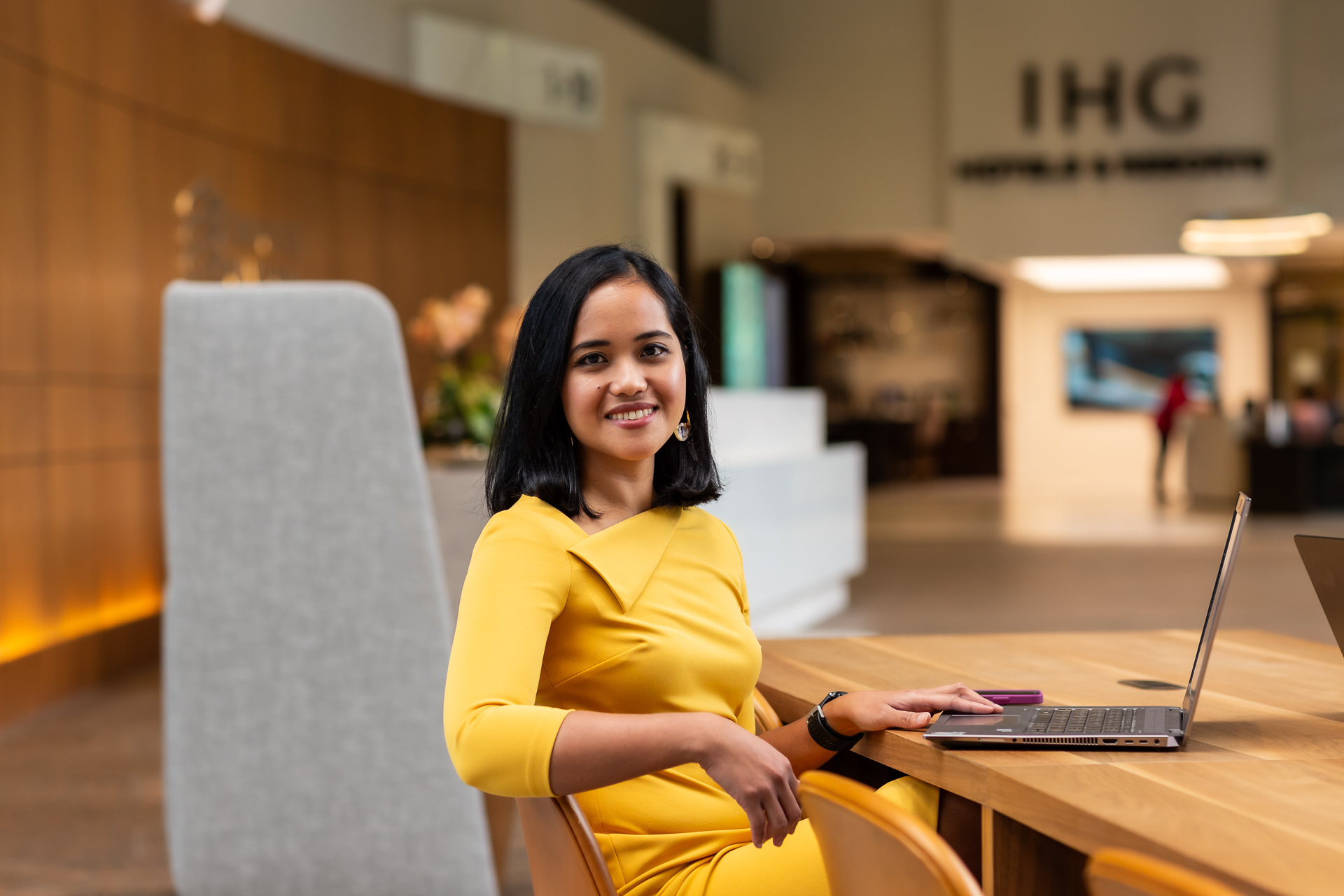 commercial photo of a female executive working on a laptop in a corporate office