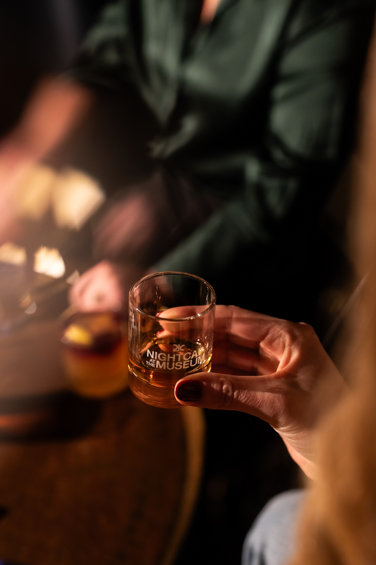 commercial photography at 21C museum hotel of a small whiskey glass being held