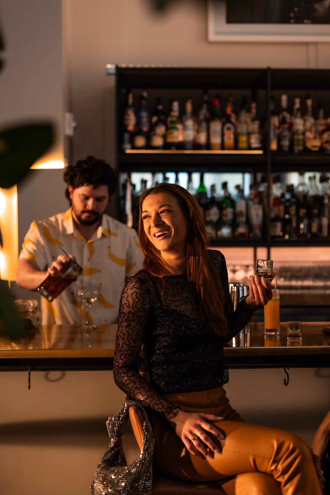 commercial photography of a woman sitting at the bar at 21C museum hotel 
