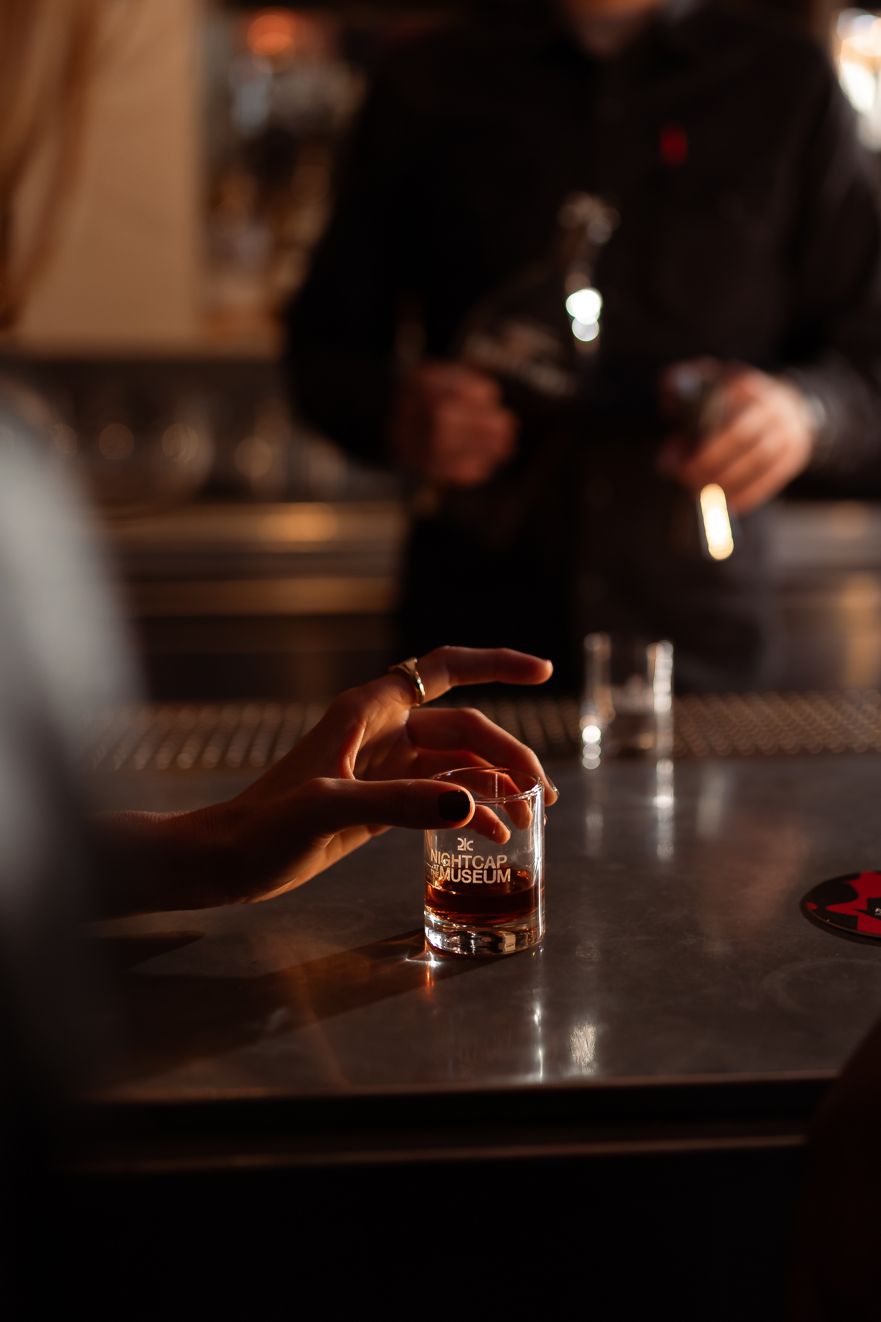 commercial photography at 21C museum hotel of a nightcap bourbon being poured