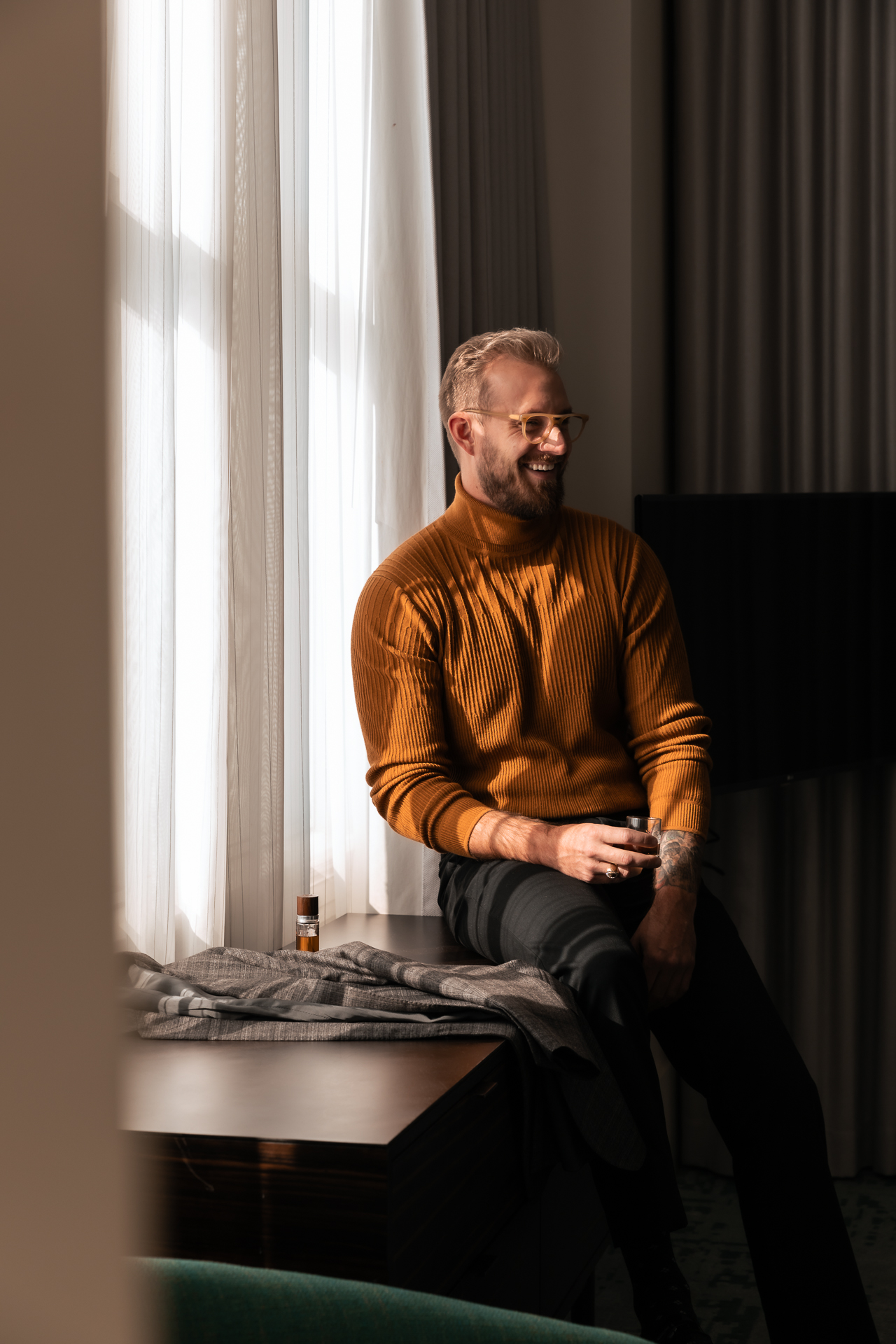 commercial photography at 21C museum hotel of a man sitting near a window in the hotel room