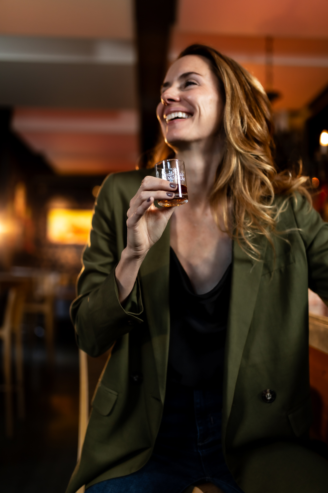 commercial photography at 21C museum hotel of a woman holding a drink at the bar