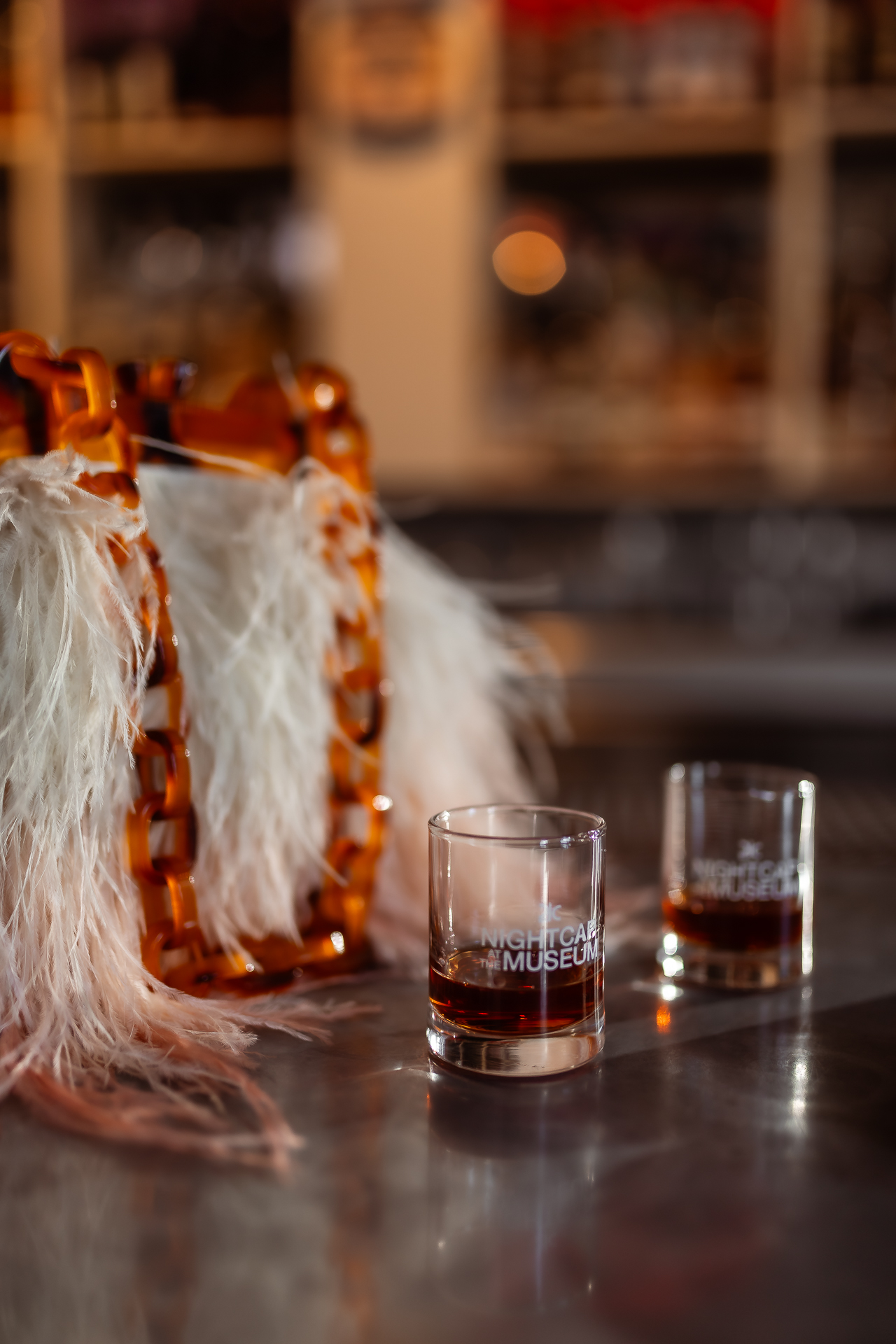 commercial photography at 21C museum hotel of two drinks and a feather purse on the bar