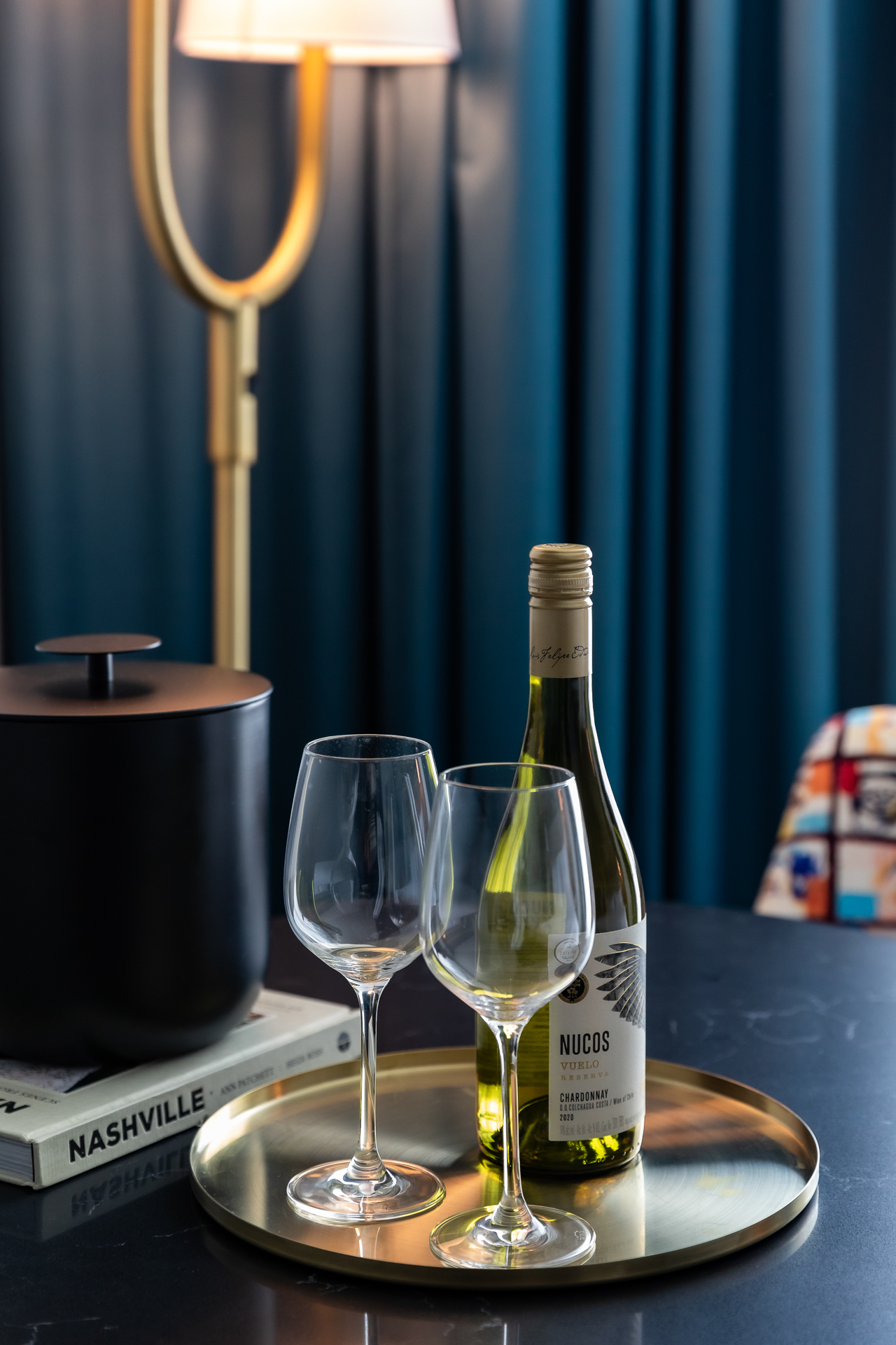 commercial photography of a bottle of wine and glasses on a table at Tempo Nashville