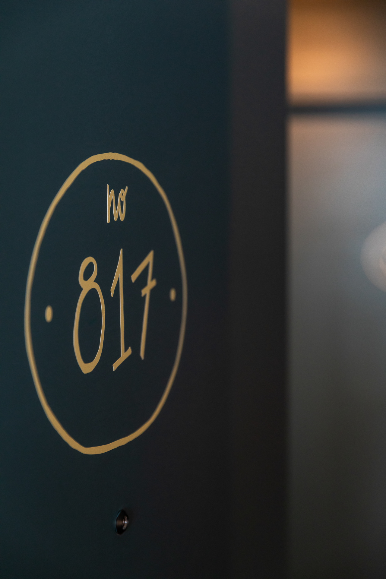 commercial photography of a room number painted on the door at Tempo Nashville