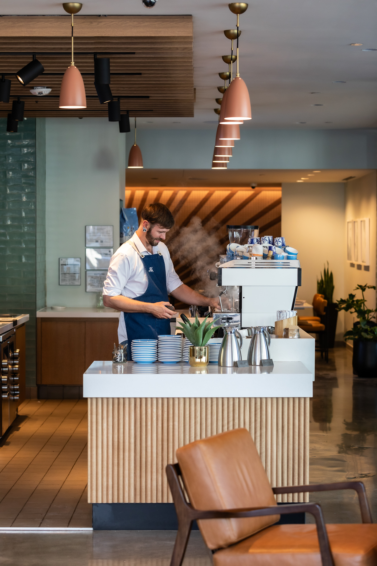 commercial photography of a barista making coffee at Bluestone Lane in Tempo Nashville