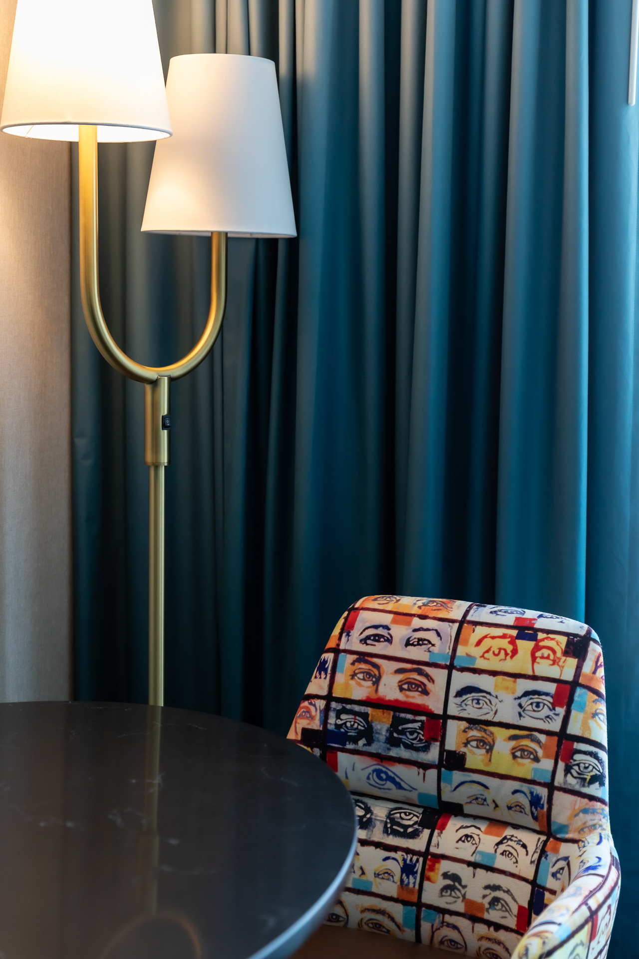 commercial photography of a chair and lamp in a hotel guest room 