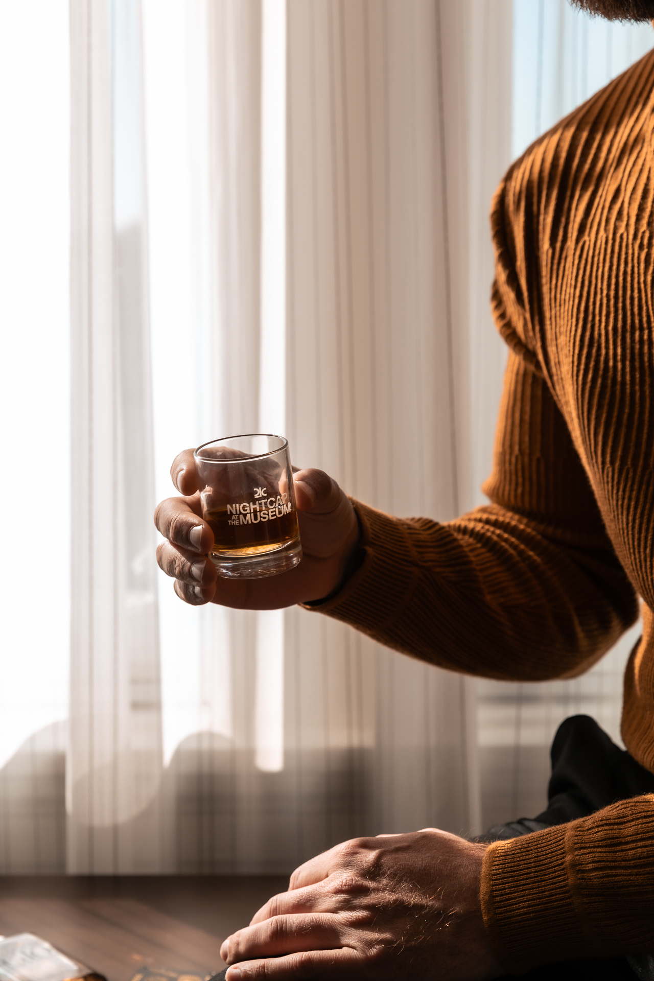 commercial photography at 21C museum hotel of a man holding a drink