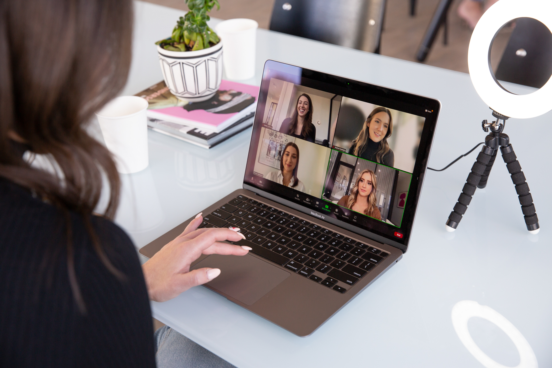 someone on a video call with others girls on a laptop