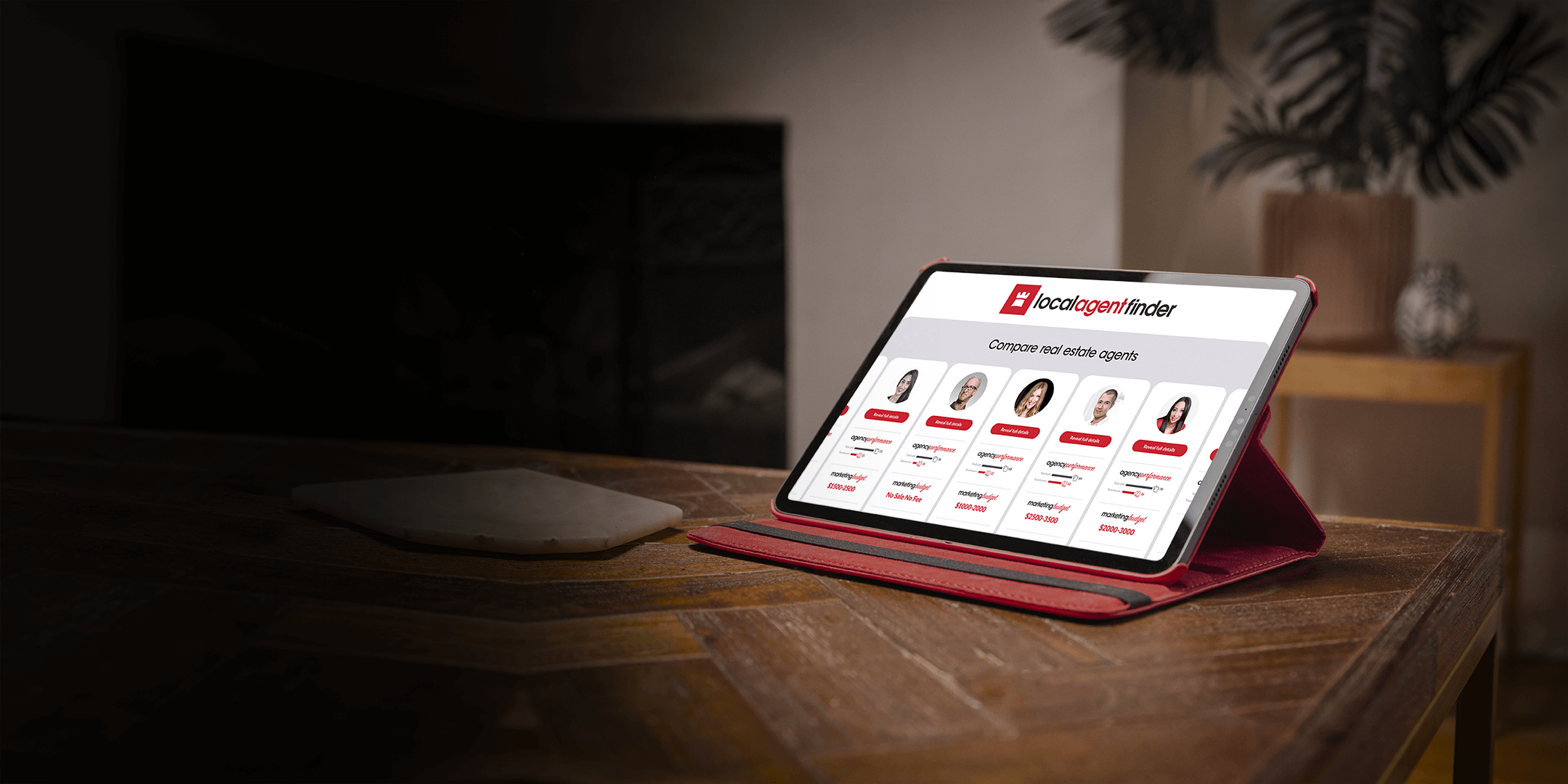 A tablet sitting on top of a wooden table.