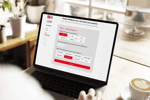 A person sitting in front of a laptop computer.