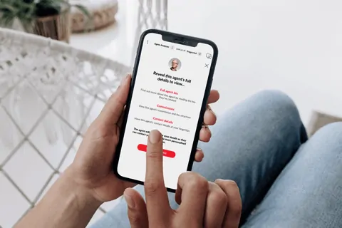 A person holding a cell phone in their hand.