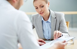 A woman sitting at a table with a man.