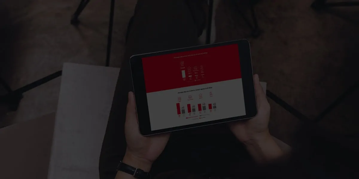 A person holding a tablet with a bar chart on it.