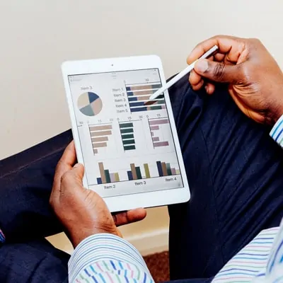 A man holding a tablet with a chart on it.