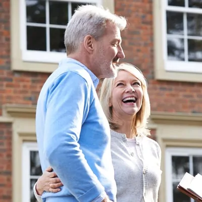 A man and a woman standing outside of a building.