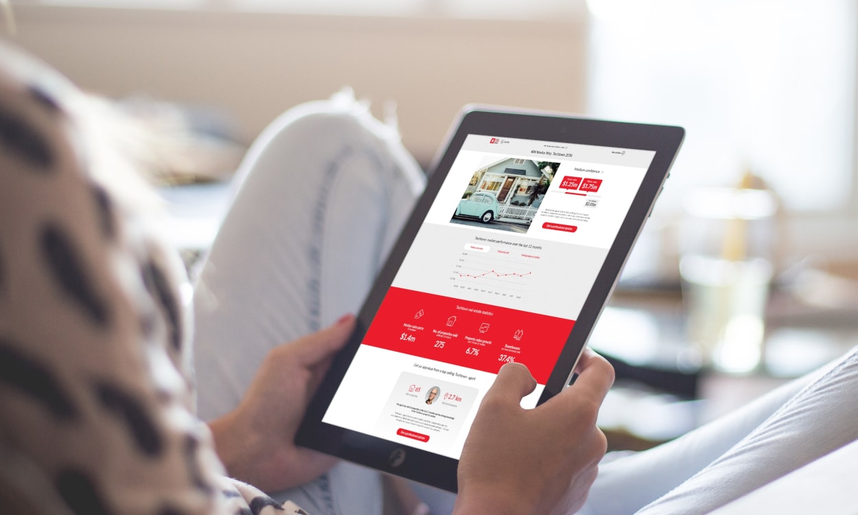 A person sitting on a couch holding a tablet.