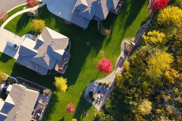 An aerial view of a home surrounded by trees.
