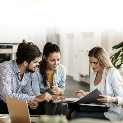 A group of people sitting around a table.