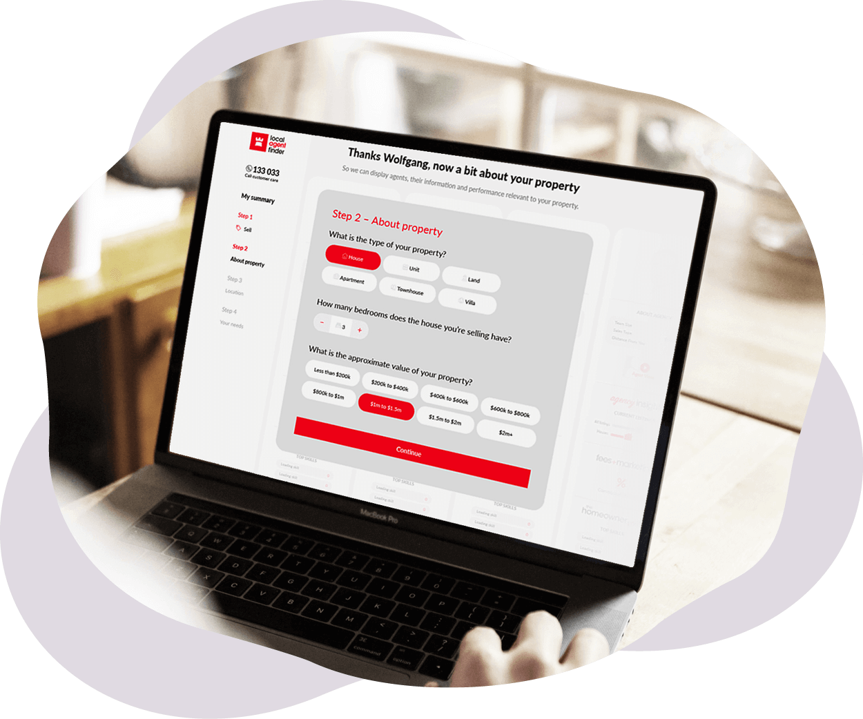 A person using a laptop computer on a table.