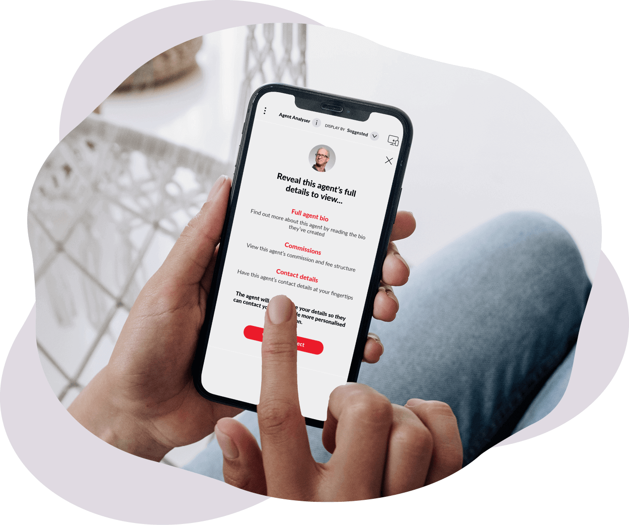 A person holding a phone with an agents profile on the screen.