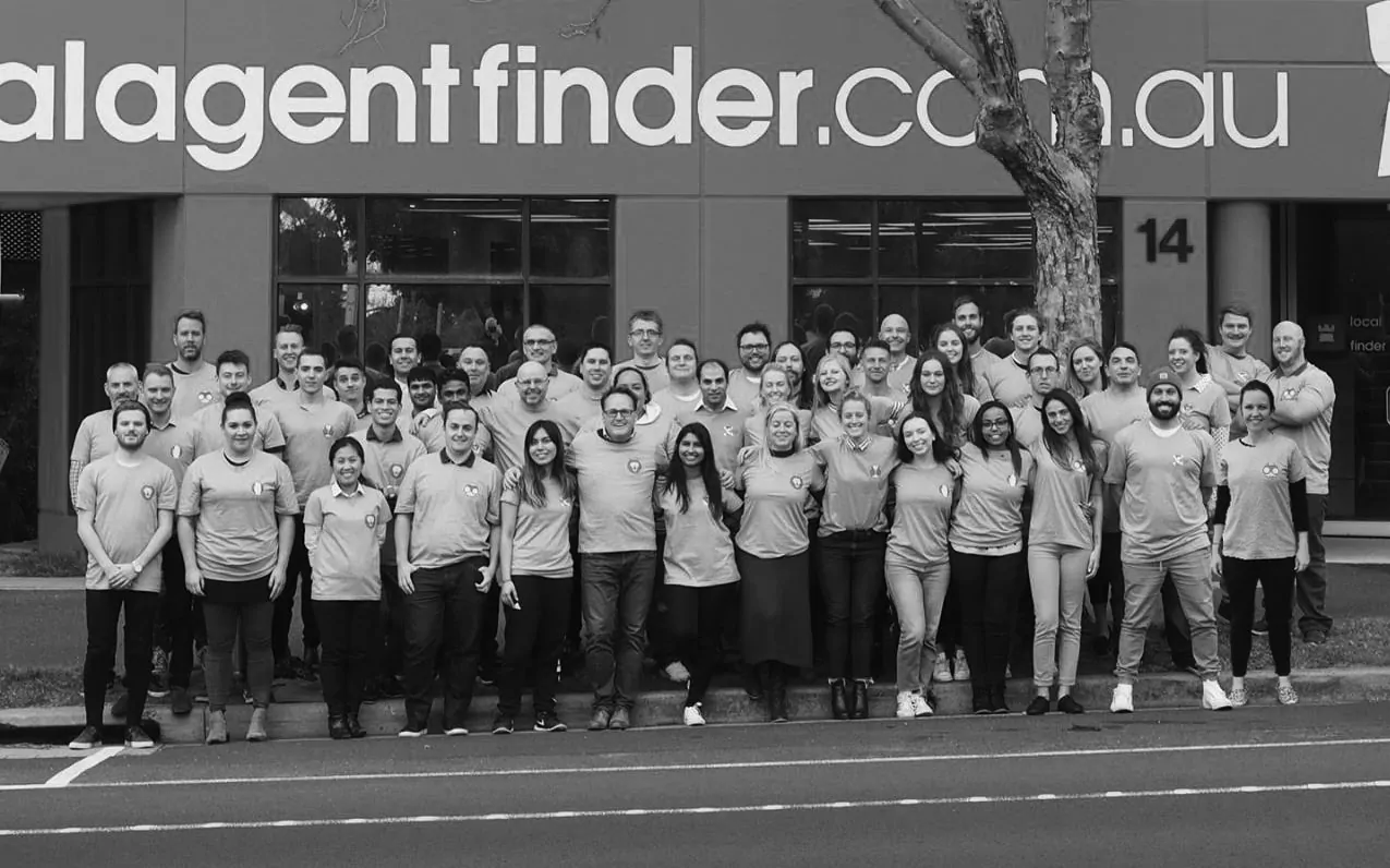 A group of people standing in front of a building.