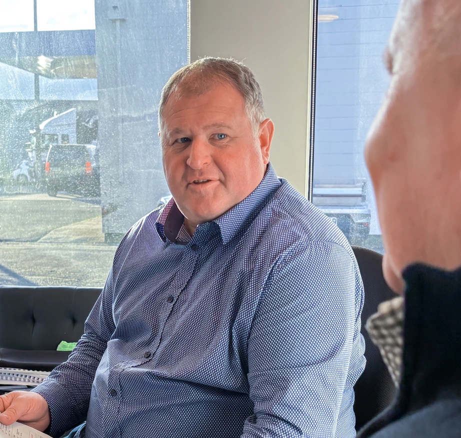 An photo of Darryn mid-conversation with a client. The client is cropped out of frame, focusing on Darryn's face only.