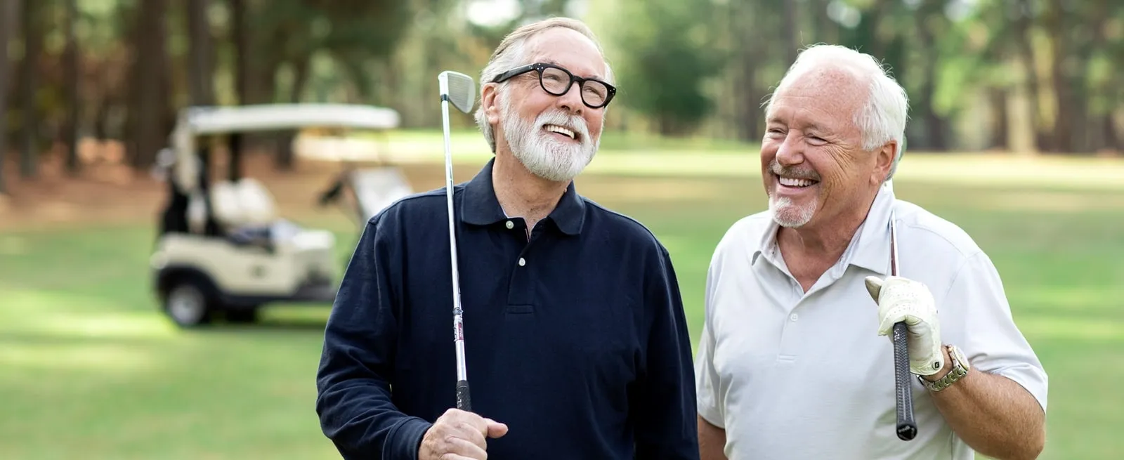 Two senior residents enjoying golf together at The Village at Woods Edge.