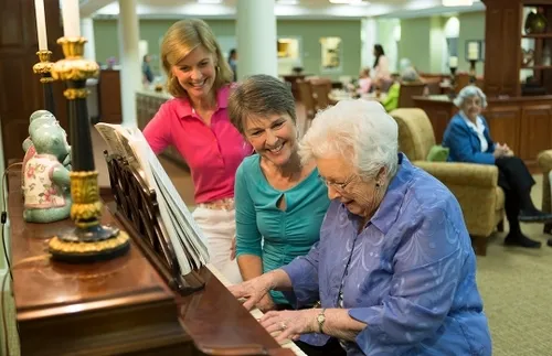 Residents playing the piano at The Village at Woods Edge Retirement Community.