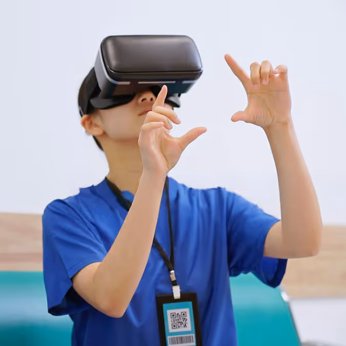 A boy wearing a blue shirt is using a virtual headset.