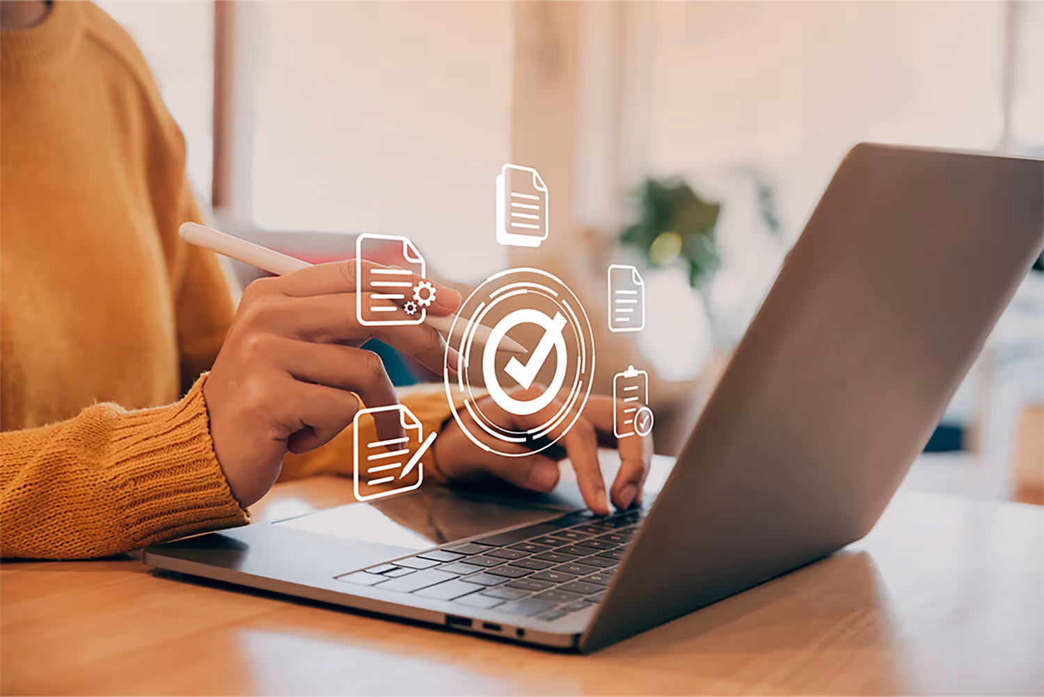 A person using a laptop with icons coming out of it.