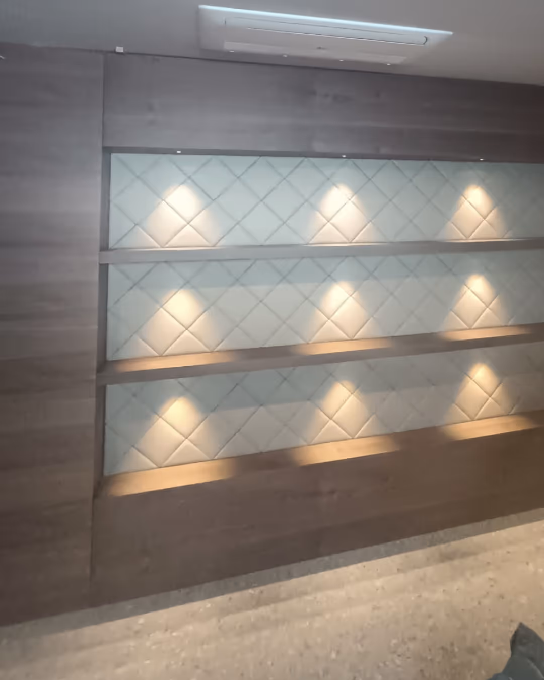 Moderne drvene police s LED rasvjetom na zidu.