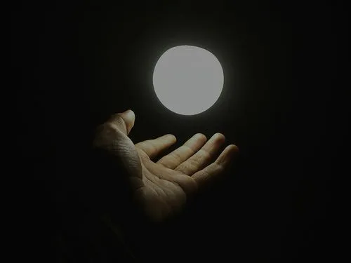 Hand in front of a moon