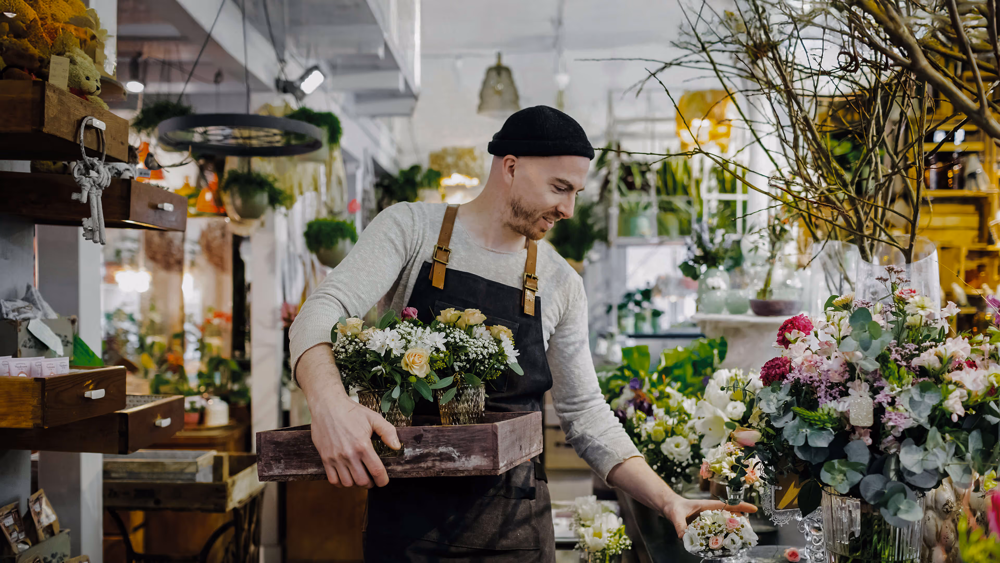 Florist arranging bouquets in a shop, reflecting personalized digital retail and eCommerce optimization