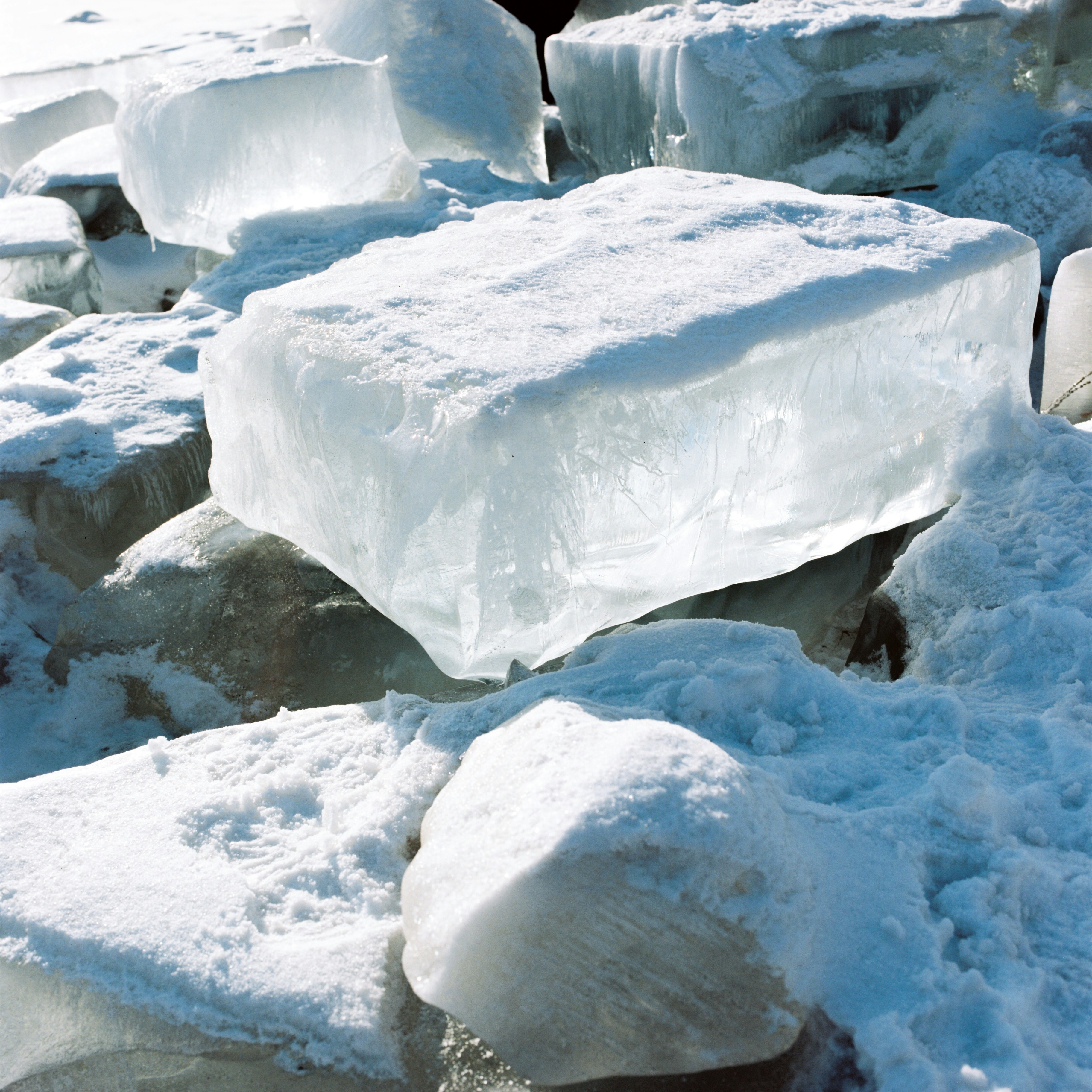 Ice climber scaling frozen waterfall, representing resilience and advanced logistics in cold environments