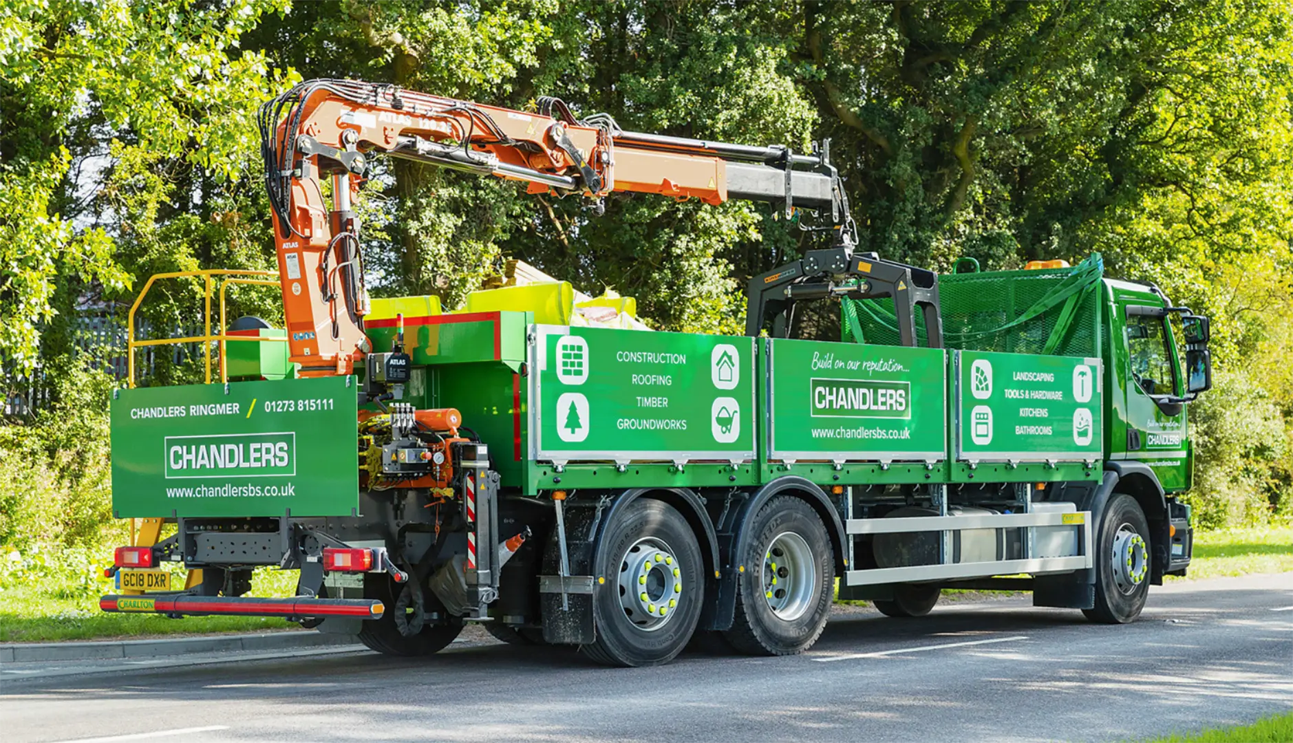 Green Chandlers Builders Merchant lorry with branded sign-writing.